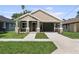 Charming home featuring a covered front porch, stone accents, and a well-manicured lawn at 5703 N 20Th St, Tampa, FL 33610