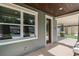 View of the front porch showcasing the stone pillars and front door with sidelight window at 5703 N 20Th St, Tampa, FL 33610