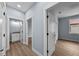 Hallway featuring blue walls, light wood-look vinyl flooring, and white trim at 5703 N 20Th St, Tampa, FL 33610