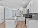 Beautiful white kitchen featuring gray countertops, a tile backsplash, and stainless steel appliances at 5703 N 20Th St, Tampa, FL 33610