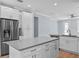 Open kitchen featuring a center island, stainless steel refrigerator, and modern lighting at 5703 N 20Th St, Tampa, FL 33610