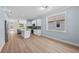 Bright, open kitchen with stainless appliances, white cabinetry, and hardwood floors at 5703 N 20Th St, Tampa, FL 33610