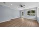 Well-lit living room with hardwood floors, a ceiling fan, and a glass paneled door at 5703 N 20Th St, Tampa, FL 33610