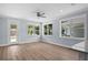 Open living space featuring hardwood floors, natural light, and view to kitchen at 5703 N 20Th St, Tampa, FL 33610