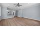 Spacious living room with hardwood floors, fan, and light blue walls at 5703 N 20Th St, Tampa, FL 33610