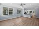 Bright open-concept living room with hardwood floors, recessed lighting, and view of the kitchen at 5703 N 20Th St, Tampa, FL 33610