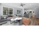 Open-concept living room featuring a modern kitchen, comfortable seating, and abundant natural light at 5703 N 20Th St, Tampa, FL 33610