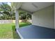 A beautiful and shaded back porch overlooks the yard at 5705 N 20Th St, Tampa, FL 33610