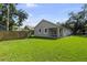 Spacious backyard with lush green grass and mature trees at 5705 N 20Th St, Tampa, FL 33610