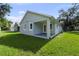Green backyard with fresh grass and access to the back porch at 5705 N 20Th St, Tampa, FL 33610