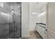 Sleek bathroom featuring a glass enclosed shower and modern vanity with double sinks at 5705 N 20Th St, Tampa, FL 33610