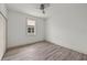 A bright bedroom with a ceiling fan, base trim, and a large window at 5705 N 20Th St, Tampa, FL 33610