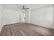 Large bedroom with hardwood floors, white walls, and a ceiling fan at 5705 N 20Th St, Tampa, FL 33610