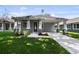 Charming single-story home with a well-manicured lawn, gray siding, and inviting front porch at 5705 N 20Th St, Tampa, FL 33610