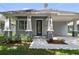 Close up of the home's gray exterior, decorative glass front door, and landscaped entryway at 5705 N 20Th St, Tampa, FL 33610