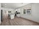 Open concept kitchen with a large island, stainless appliances, and hardwood flooring at 5705 N 20Th St, Tampa, FL 33610