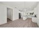 Open-concept kitchen connects to the living space, featuring hardwood floors and modern finishes at 5705 N 20Th St, Tampa, FL 33610