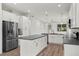 Bright, spacious kitchen features a large island, stainless steel refrigerator, and white cabinetry at 5705 N 20Th St, Tampa, FL 33610