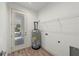 A bright laundry room with a water heater and wire shelving at 5705 N 20Th St, Tampa, FL 33610