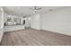 Spacious, open-plan living room featuring light hardwood flooring and contemporary design at 5705 N 20Th St, Tampa, FL 33610
