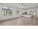 Open-concept living room with hardwood floors flowing into the kitchen area and natural light at 5705 N 20Th St, Tampa, FL 33610