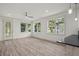 Open-concept living area with sleek floors, large windows, and access to the kitchen at 5705 N 20Th St, Tampa, FL 33610