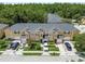 Aerial view of well-maintained townhomes with lush landscaping and multiple parked cars at 6234 Ashbury Palms Dr, Tampa, FL 33647