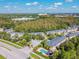 Aerial view of townhomes with community pool surrounded by lush greenery, palm trees and manicured grounds at 6234 Ashbury Palms Dr, Tampa, FL 33647