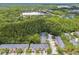 Aerial view featuring the townhome community surrounded by lush greenery and nearby commercial areas at 6234 Ashbury Palms Dr, Tampa, FL 33647