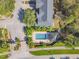 Aerial view of a community pool with lush landscaping, sun loungers, and nearby condominium buildings at 6234 Ashbury Palms Dr, Tampa, FL 33647