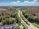 Scenic aerial of the community featuring mature trees, ponds, and proximity to nature with blue skies at 6234 Ashbury Palms Dr, Tampa, FL 33647