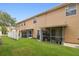 Spacious backyard featuring covered screened in porches and green grass at 6234 Ashbury Palms Dr, Tampa, FL 33647