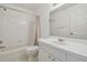 Clean bathroom featuring tiled walls, a shower-tub combo, and single sink vanity with storage at 6234 Ashbury Palms Dr, Tampa, FL 33647