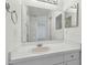 Bright bathroom featuring a large mirror, white vanity, and views into adjacent rooms at 6234 Ashbury Palms Dr, Tampa, FL 33647