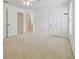 Spacious bedroom with carpet, white walls, ceiling fan and multiple doors and windows at 6234 Ashbury Palms Dr, Tampa, FL 33647