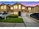 Inviting townhome showcases a well-maintained lawn, charming yellow and white facade, and private driveways at 6234 Ashbury Palms Dr, Tampa, FL 33647