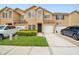 Charming two-story townhouse with attached garages and a well-manicured front lawn at 6234 Ashbury Palms Dr, Tampa, FL 33647