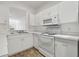 Bright kitchen features white cabinetry and a modern microwave at 6234 Ashbury Palms Dr, Tampa, FL 33647