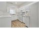 Well-lit kitchen features white appliances, cabinets, and counters at 6234 Ashbury Palms Dr, Tampa, FL 33647