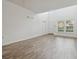 Spacious living room with tall ceiling, natural light, and wood-look flooring at 6234 Ashbury Palms Dr, Tampa, FL 33647