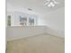Bright living space with carpet, white walls, fan, and windows with views of neighboring homes at 6234 Ashbury Palms Dr, Tampa, FL 33647
