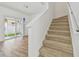 Carpeted staircase leading to the upper level, adjacent to a living area with sliding glass doors at 6234 Ashbury Palms Dr, Tampa, FL 33647