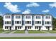 New townhome construction with a modern design, light blue accents, and well-maintained landscaping at 6605 N Nebraska Ave # 11, Tampa, FL 33604
