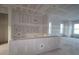 Spacious living room under construction, featuring abundant natural light from large windows at 6605 N Nebraska Ave # 11, Tampa, FL 33604
