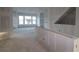 Partially constructed living area with large windows, showcasing the potential of the space at 6605 N Nebraska Ave # 11, Tampa, FL 33604