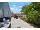 Spacious backyard with patio furniture, playhouse, and lush landscaping at 7534 Oxford Garden Cir, Apollo Beach, FL 33572