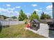 Fenced backyard with a playhouse, trampoline, and ample space for outdoor activities at 7534 Oxford Garden Cir, Apollo Beach, FL 33572