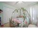 Charming bedroom with a decorative bed frame, tile floor and a double-door closet creating a delightful space at 7534 Oxford Garden Cir, Apollo Beach, FL 33572