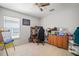 Bedroom with a window, neutral walls, and tile flooring, furnished with a desk and chair setup at 7534 Oxford Garden Cir, Apollo Beach, FL 33572