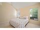 Spacious bedroom featuring tile flooring, a bed with decorative pillows, and natural light through three windows at 7534 Oxford Garden Cir, Apollo Beach, FL 33572